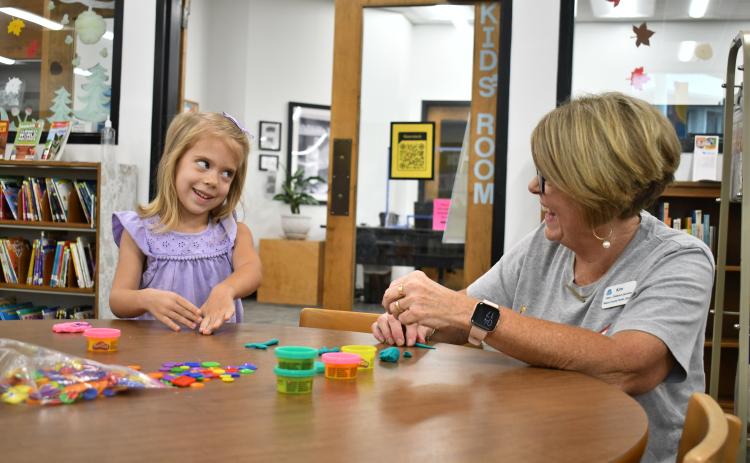 Megan Horn/The Clayton Tribune. Kate Getty, 4, has fun making Play-Doh creations with Kim Cannon, Children’s Services, during the “1,000 Books Before Kindergarten” kickoff event at the Rabun County Public Library Sept. 21.