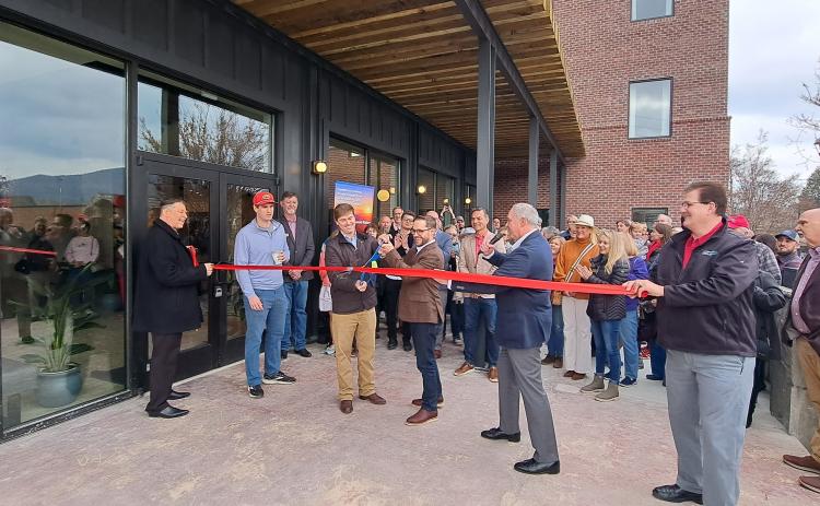 Megan Horn/The Clayton Tribune. Local officials and community members celebrate as the Bridge Creek Inn cuts the ribbon with Forward Rabun/Rabun County Chamber of Commerce during the Open House event Nov. 25.