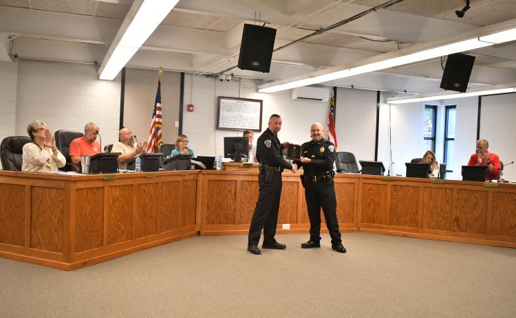 Megan Horn/The Clayton Tribune. Clayton Police Department Assistant Chief John Grist is recognized for 15 years of exemplary service to the city and is presented with a plaque by Chief Andy Strait on Oct. 17.