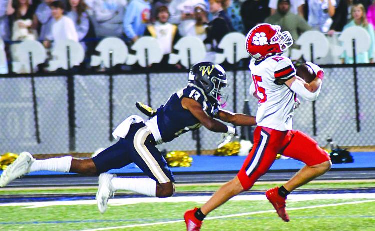 Enoch Autry/The Clayton Tribune. Wildcat running back Reid Giles breaks multiple tackles at the line of scrimmage and then outraces John Durden and other Whitefield Academy WolfPack defenders 56 yards for a touchdown. Reid led the Wildcats in rushing with 104 yards and two scores in RCHS’s 42-14 win to move into the state Elite Eight.
