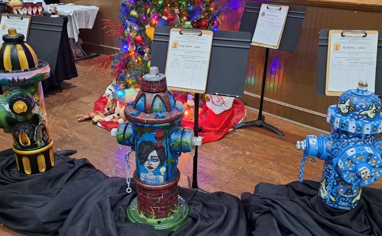 Megan Horn/The Clayton Tribune. These fire hydrants were decorated by local artists Amy Jarrard, Lizzy Falcon and Kip Ramey and auctioned off during this year’s  Holiday Market and Festival of Trees. The event raised $10,573 for Rabun Paws 4 Life.