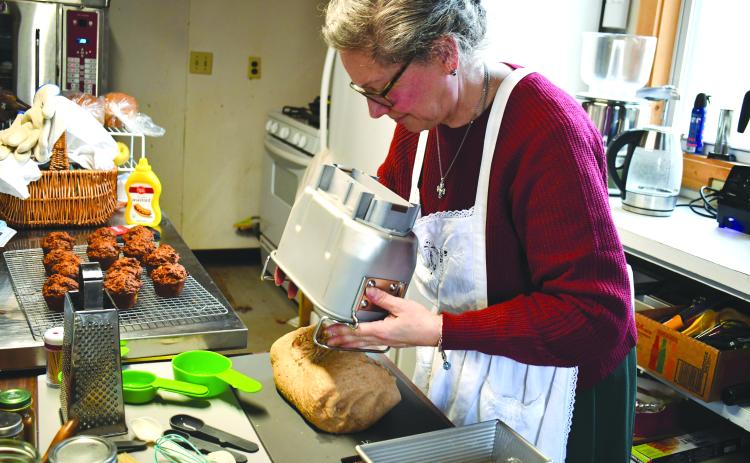 Megan Horn/The Clayton Tribune. Anne Weingartz kneads fresh dough made from wheat she milled herself at Quizzical Farm Bakery in Rabun Gap.
