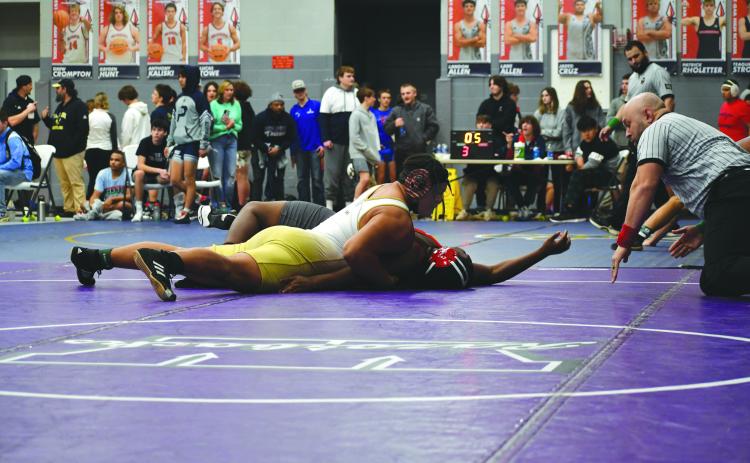 Wade Cheek/The Clayton Tribune. RGNS senior wrestler and football player Kaleb McKenzie pins his opponent to advance to the quarterfinal-round of the 285-pound weight class during Rabun Gap’s tournament at West Oak High School.