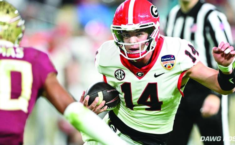 Dawg Post. Current Bulldog and former Rabun County star quarterback, Gunner Stockton, weaves his way through Hard Rock Stadium in Miami during the Orange Bowl. The redshirt freshman threw for 96 yards and two TDs.