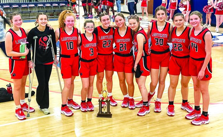 Photo provided to The Clayton Tribune. RCMS seventh and eighth-grade Lady Cats stand with their hardware after earning runner-up after last Saturday’s middle school tournament championship game. RCMS defeated Stephens County 50-20 in the semi-final but lost to Elbert County in the title game 42-36. (From left) Lady Cats Kinsey Huff, Cheyenne Queen, Irie McElroy, Maci Dixon, Millie Southards, Sophie Provance, Shay Woods, Cecelia Fields, Danni Blalock and Lydia Gergani. Melissa Weeks is the head coach.