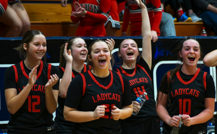 Wade Cheek/The Clayton Tribune. RCHS Lady Cat hoopers (from left) Conley Spivey, Chloe Erlewine, Loren Mazarky, Jamie McCall and Mili Watts celebrate their fellow basketball teammates from the sideline of last Friday’s region battle with Elbert County on Jan. 19. The Lady Cats have a lot to be happy about these days. As of Thursday, Jan. 25, RCHS head coach DeeDee Dillard and the Lady Cats are 16-5 and 3-1 in region play. RCHS also is currently the No. 4 team in Georgia Class A Division I.