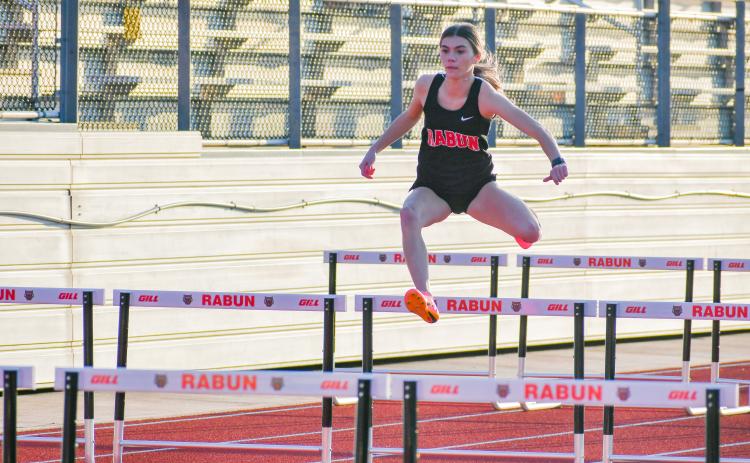 Wade Cheek/The Clayton Tribune. RCHS senior track runner Christina Keller glides through the girls 100 hurdles event during Rabun County’s season opener at Frank Snyder Memorial Stadium in Tiger on Tuesday, Feb. 20.