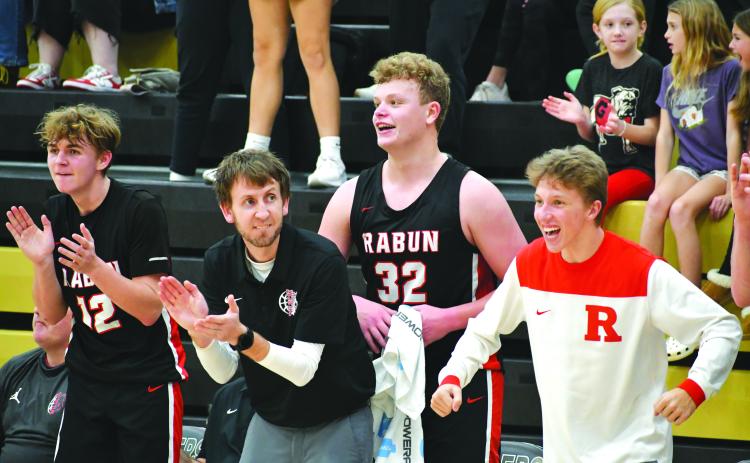 Wade Cheek/The Clayton Tribune. RCHS head boys basketball coach David Adcock cheers on his Wildcats as his players Reed Burrell, Jack Hood and Colton Crane cheer on their teammates during a big performance against Commerce.
