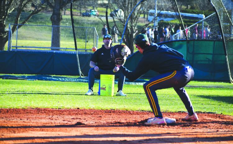 Wade Cheek/The Clayton Tribune. RGNS head baseball coach Clark Wright does infield work with Eagle senior Argenis Lopez at third base during a Feb. 13 practice. The Eagles will kick off their season Friday, Feb. 16 against North Atlanta at Pickens County High School.