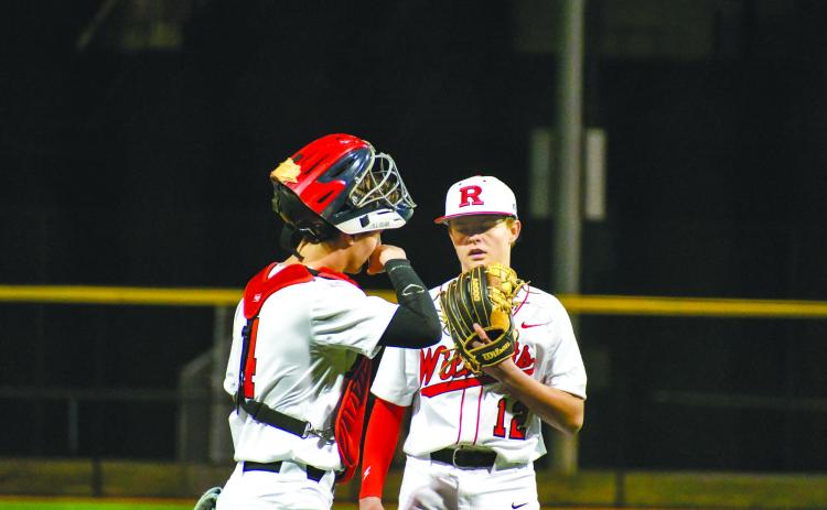 Wade Cheek/The Clayton Tribune. Rabun County pitcher and second baseman Hunter Giles has a meeting at the mound with sophomore catcher Noah English during the Wildcats’ home opener versus Union County on Feb. 14.