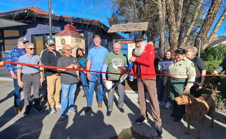 Megan Horn/The Clayton Tribune. Forward Rabun/Rabun County Chamber of Commerce cuts the ribbon on the new Appalachian Trail (AT) Community Kiosk located near the Rock House on Main Street in Clayton March 7. Community citizens, officials from the City of Clayton and county, and AT Community Committee members participated in the event.