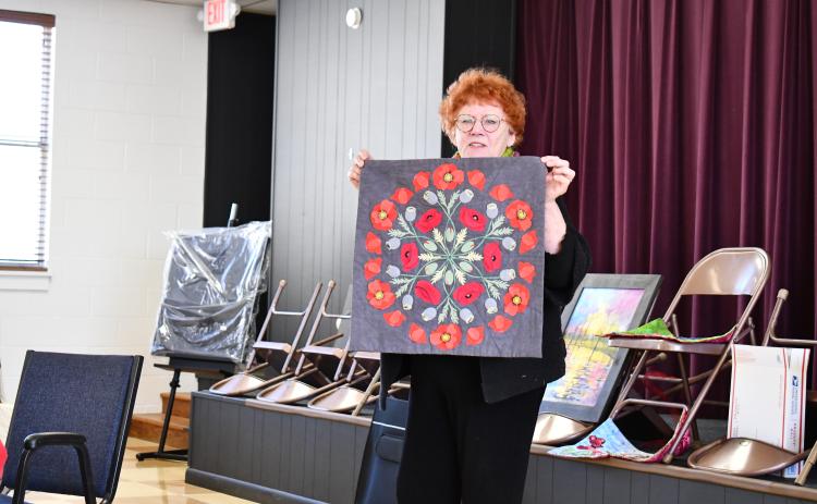 Megan Horn/The Clayton Tribune. Silke Cliatt showcases fabric art with a brightly colored Mandala made with slow hand stitching during the North Georgia Arts Guild “Show and Tell” showcase Feb. 15. Cliatt said the inspiration came from a Poppy flower.
