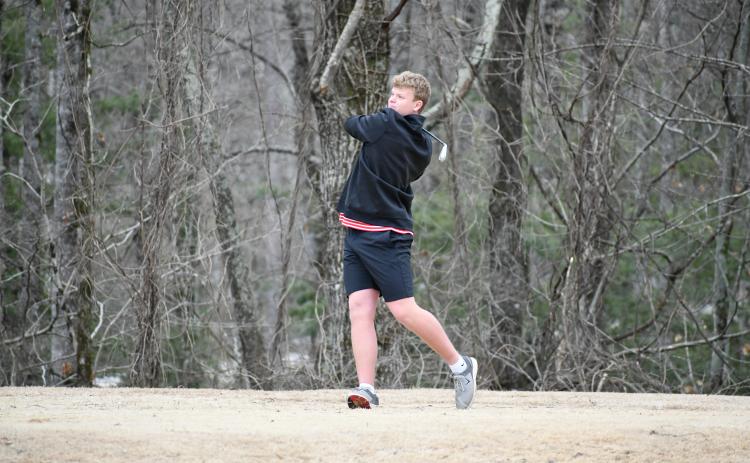 Wade Cheek/The Clayton Tribune. RCHS senior Jack Hood drives off the tee at Kingwood Resort during the Wildcat golf team's match against Dawson County on Feb. 29. Hood shot a 38 to help RCHS win 176-186.