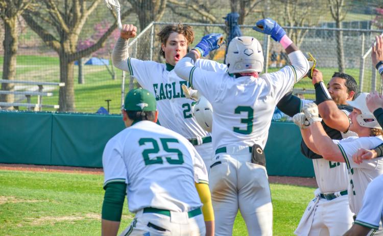 Wade Cheek/The Clayton Tribune. RGNS junior outfielder Jeremy Ramos celebrates with his Eagle teammates after hitting one of his four home runs during Rabun Gap’s 23-0 win over Carolina Day School on Tuesday, March 19.