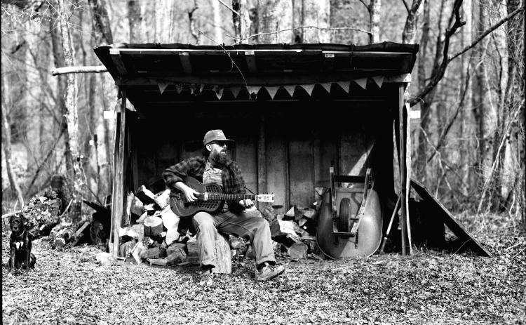 Photo courtesy Ronnie Pettit. This black-and-white photograph by Ronnie Pettit shows Rabun County resident Scott Low as he promotes his new album “Appalachian Blues.” Low has release parties scheduled in three states.