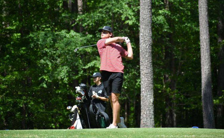 Wade Cheek/The Clayton Tribune. RCHS senior golfer Blake Weber tee's off during the Area I tournament last Monday, April 22 at Arrowhead Pointe Gold Course in Elbert County.