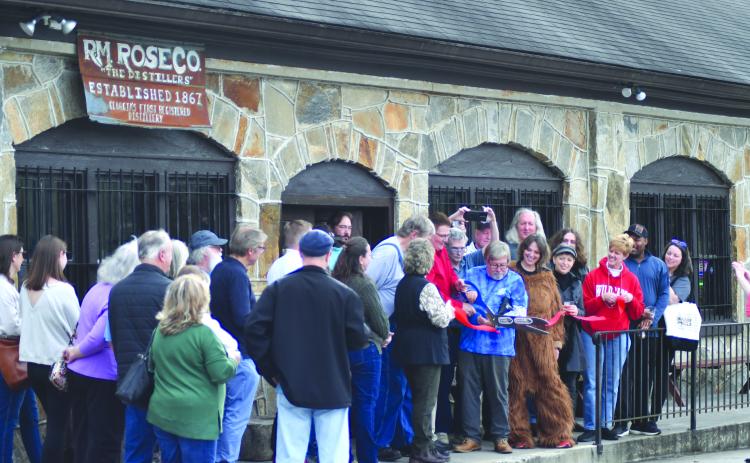 Enoch Autry/The Clayton Tribune. Dr. John Stamey cuts the ribbon for Forward Rabun and Rabun County Chamber of Commerce.