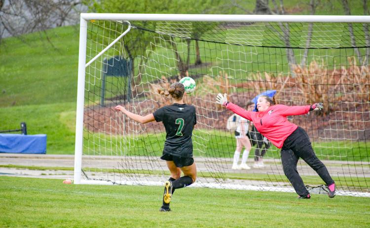 Wade Cheek/The Clayton Tribune. RGNS senior forward Georgia Mattis watches her first of three goals pierce the net during a cross-county match against Tallulah Falls School on Tuesday, April 9. Rabun Gap improved to 10-2.