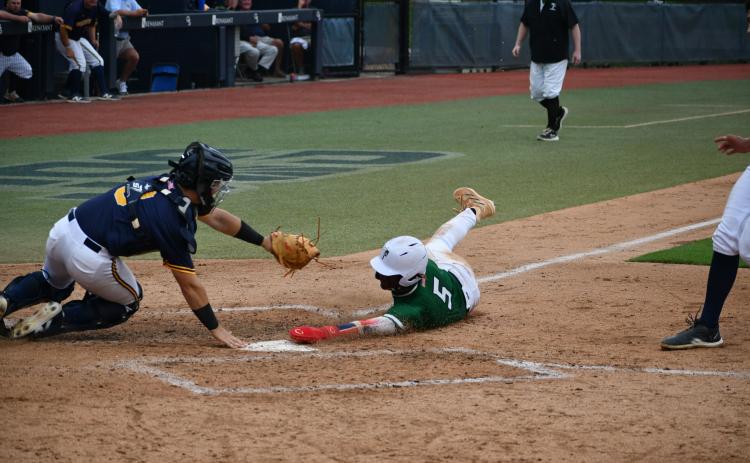 Wade Cheek/The Clayton Tribune. ABOVE: Talluah Falls School junior outfielder Danny Grant extends his hand into home plate for a run in the state title but is called out after a controversial call that helped Prince Avenue come back and win Game One of this year’s Class A D-I state title.