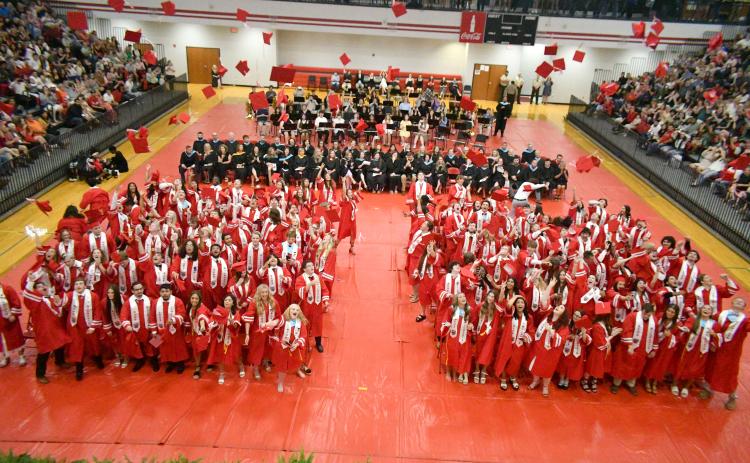 Wade Cheek/The Clayton Tribune. The members of the Class of 2024 from Rabun County High School toss their caps into the air inside the campus gym upon graduation.