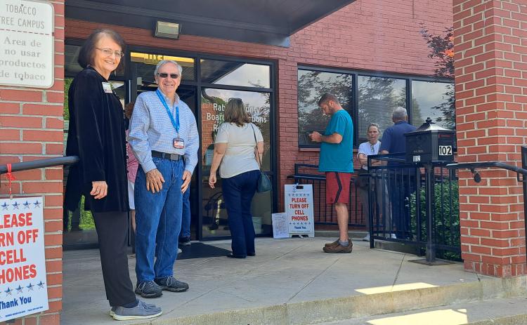 Megan Horn/The Clayton Tribune. Rabun Countians showed up to vote on Election Day as the line at the polls overflowed out the door and those registered waited to check in and vote at the Rabun County Elections Office Tuesday, May 21. Those casting their ballots did not see a long wait time. Above, pictured from left are poll workers Glenda Enloe and Rick Crouse.