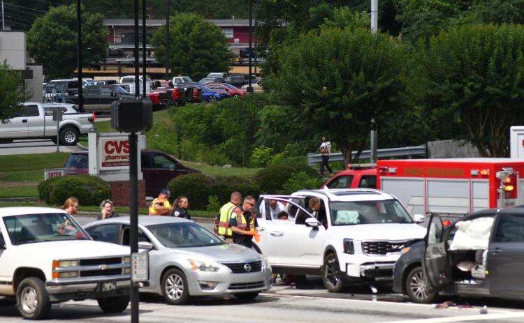 Enoch Autry/The Clayton Tribune. Clayton Police Department officers work the scene of a two-vehicle collision at the intersection of Ga. 15 and Chechero Street the morning of June 20. Minor injuries were reported with the crash.