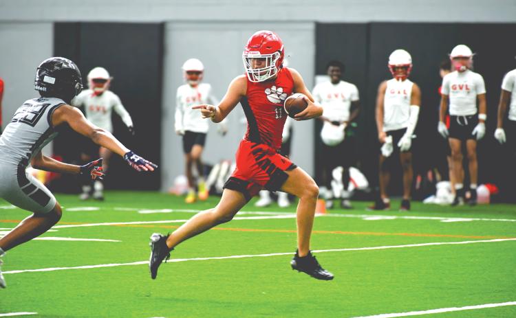 Wade Cheek/The Clayton Tribune. Rabun County football wide receiver Jake Payne speeds by an Alpharetta defender for a touchdown during a 7-on-7 camp at the University of Georgia on Thursday, June 20. The Wildcats played four games within the Bulldogs’ “House of Payne” indoor facility with a number of UGA football coaches and players watching.
