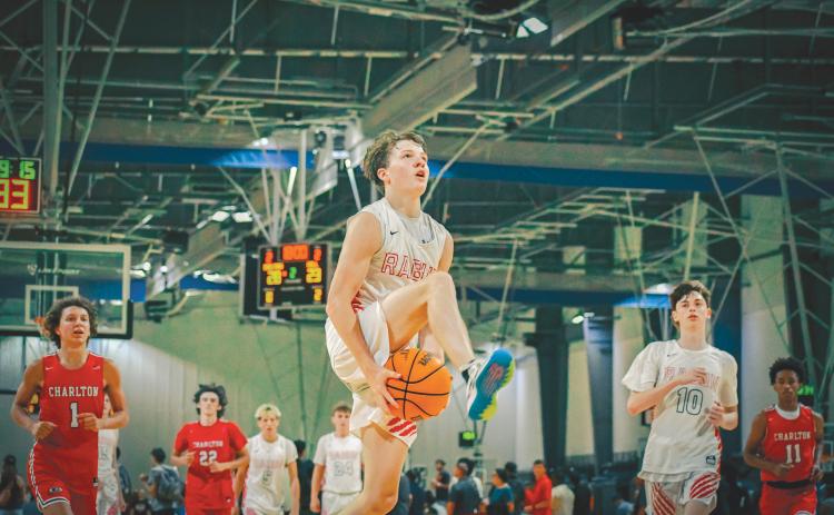 Wade Cheek/The Clayton Tribune. RCHS junior guard Huey Blalock goes between the legs for a fast-break layup during the Wildcats’ 29-point win over Charlton County at the LakePoint Sports Complex on Sunday, June 23. Blalock and the Wildcats finished this summer season 18-4.