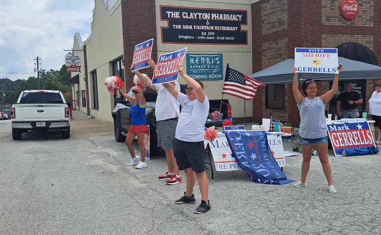Megan Horn/The Clayton Tribune. Mark Gerrells supporters campaign and cheer on Main Street as passing vehicles honk on Election Day. Gerrells defeated incumbent Sheriff Chad Nichols in Tuesday’s Republican runoff 1,878 votes to 351.