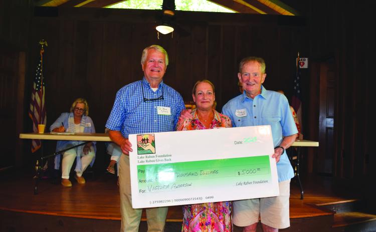 Submitted photo. Steve Raeber and Buz Stone present Victoria Anderson with the Buz Stone Award and $5,000 grant from the Lake Rabun Foundation.