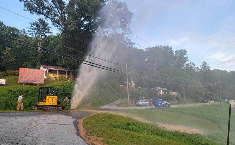 Enoch Autry/The Clayton Tribune. RCWSA personnel work to restore service following a water leak at Falcon Street near Highway 441 and Highway 76 East on the evening of  Saturday, July 20. Officials reported the water leak was caused by a failed pipe.