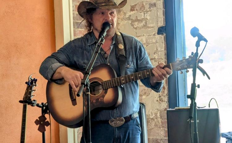 Debbie Martin/The Clayton Tribune. Tom Proctor performs at Blue Hound Barbeque in Dillard on July 19.
