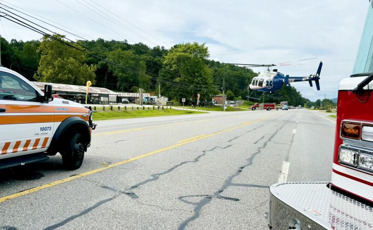 Photo from Rabun County EMS Facebook page. A helicopter lands in the roadway on Ga. 15 at its intersection with Market Circle in Rabun Gap Aug. 6 after a pedestrian was struck by a vehicle. The pedestrian was airlifted to Northeast Georgia Medical Center in Gainesville with suspected serious injuries.