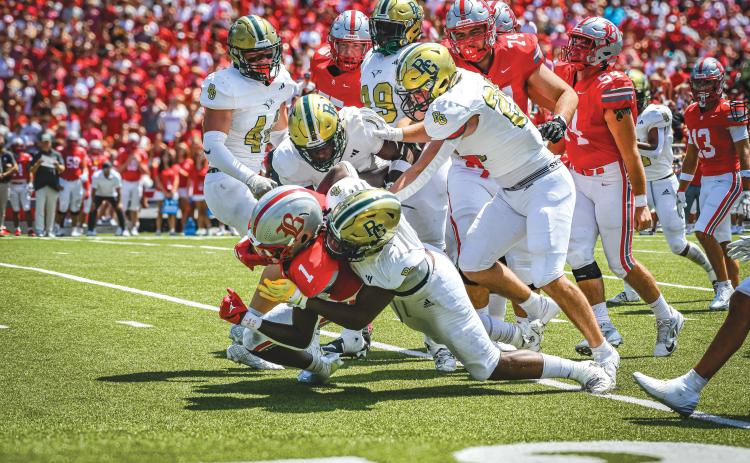 Wade Cheek/The Clayton Tribune. Multiple Rabun Gap defenders join in on a backfield tackle of Ole Miss running back commit Shekai Mills-Knight during the Eagles’ 1 p.m. bout against Baylor School that was broadcast on ESPN on Sunday, Aug. 25.