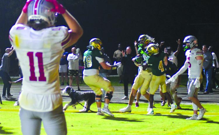 Enoch Autry/The Clayton Tribune. The Hun School’s Bryce Kania (11), a Wake Forest commit, reacts to Rabun Gap’s senior tight end Marshall Pritchett receiving congratulations in the end zone by teammates junior wide receiver CJ Willingham (4), and senior guard and Georgia Tech-commit Justin Hasenhuetl (78) after the North Carolina commit catches a touchdown pass at the end of regulation against Raiders senior free safety and Stanford-commit Liam Thorpe (5).