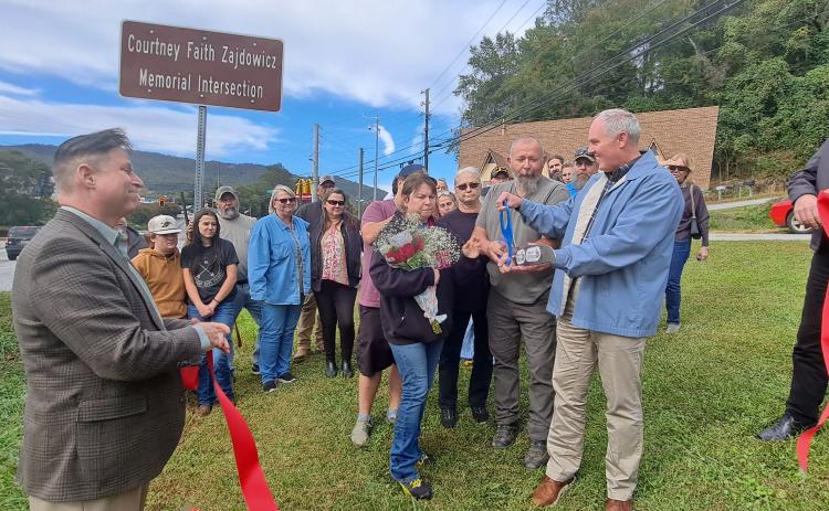 Megan Horn/The Clayton Tribune. Forward Rabun/Rabun County Chamber of Commerce members, family and friends, as well as local officials and community members cut the ribbon on the Highway 76 and Highway 441 “Courtney Faith Zajdowicz Memorial Intersection.” Zajdowicz passed away on Sept. 1, 2021.