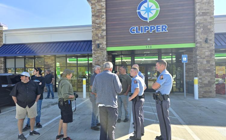 Enoch Autry/The Clayton Tribune. State representatives Lauren McDonald III and Brent Cox talk with state troopers and volunteers on their stop in Clayton on Oct. 29. Below: Michael Barlow, general manager of Troncalli Subaru of Cumming, Ga., stands with Israeli Consul General Anat Sultan-Dadon outside of Clipper Petroleum in Clayton. Barlow’s business helped fund supplies that went to Western North Carolina and Eastern Tennessee. Sultan-Dadon went with the group to provide support to the victims.