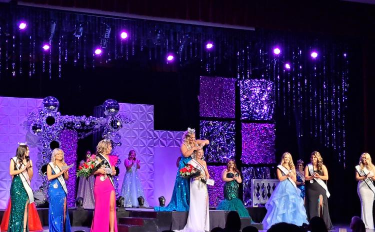 Megan Horn/The Clayton Tribune. Sayler Michelle Waldrip is crowned  2024-2025 Miss RCHS by last year’s 2023-2024 Miss RCHS winner Ashlynn York Blackwell (pictured center) on Saturday, Nov. 2. Below:  Sayler Michelle Waldrip gracefully walks across the stage at the 69th Miss RCHS Scholarship Pageant. She was crowned 2024-2025 Miss RCHS. Waldrip also was voted by the audience for the title of “Miss Sweetheart.”