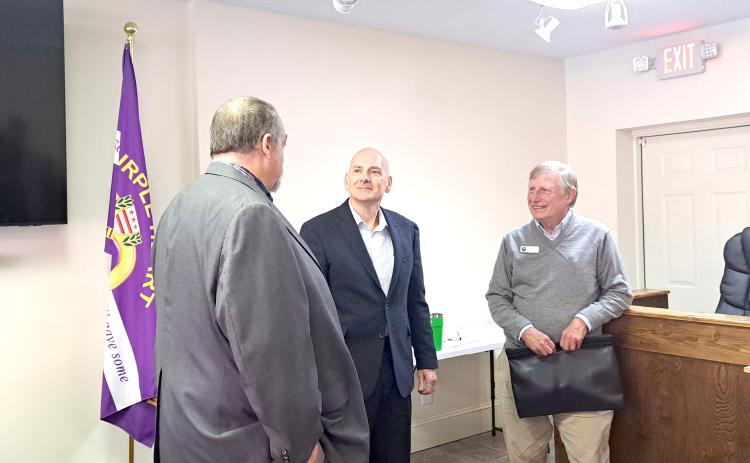 Megan Horn/The Clayton Tribune. Tim Wallis, pictured center, converses with Sky Valley city officials, City Manager Jason Streetman (left) and Council Member Jim Curtis, following Tuesday’s special called council meeting where Wallis was introduced as the new Police Chief for the Sky Valley Police Department. He is expected to start serving as Chief the first week of December.