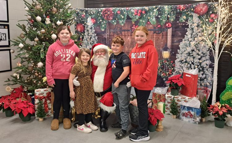 Megan Horn/The Clayton Tribune. It was a fun evening with FFA at the Rabun County Schools Agricenter “Santa on the Farm” event on Thursday, Dec. 5. Raelyn Hunnicutt, 10; Brynlee Hunnicutt, 7; Sophie Chamblee, 9; and Carter Chamblee, 7 are excited to visit Santa and tell him of their wants for Christmas.