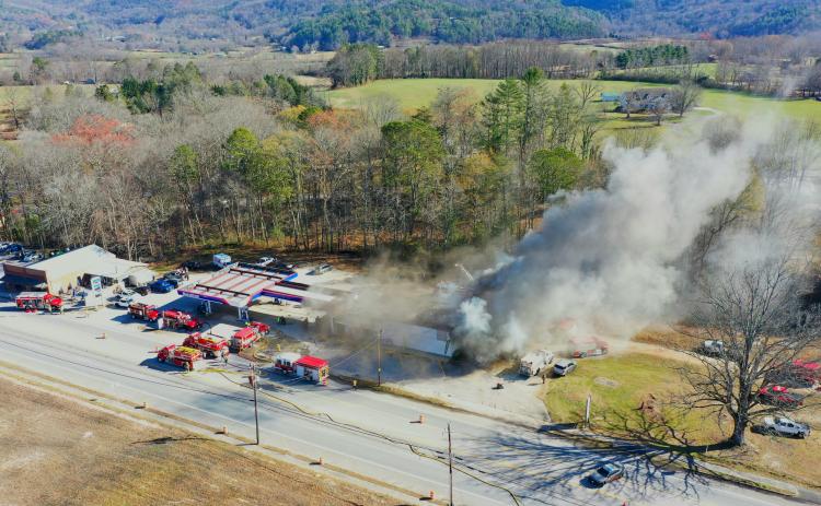 Photo courtesy of Drew Leviton. Gray smoke is seen billowing from the Marathon station in Dillard on Saturday, Dec. 7, in this aerial view captured by Drew Leviton. Firefighters work to put out the commercial structure fire at the business known locally as the Dillard Quick Shop. The cause was still undetermined and under investigation as of press time Wednesday. The building is a “total loss.”