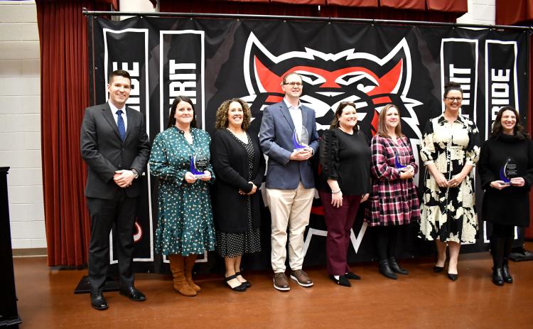 Megan Horn/The Clayton Tribune. The 2024-2025 Rabun County Schools Teachers of the Year (TOTY)were recognized during a special banquet and program on Nov. 21 in the Fine Arts Center (FAB) Band Room. Pictured are RCHS Principal Justin Spillers; RCHS TOTY Melissa Weeks; RCMS Principal Kechara Partin; RCMS and System TOTY Jason Crain; RCES Principal Keri Coleman; RCES TOTY Laurie Dills; RCPS Principal Carla Truelove; and RCPS TOTY Mary Dunham.