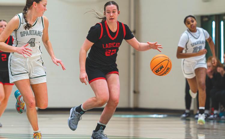 Wade Cheek/The Clayton Tribune. Senior Chloe Erlewine (22) speeds down the court with an Athens Academy defender last Saturday in a 65-32 loss to their region opponents.