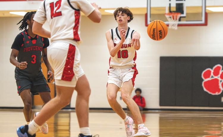 Wade Cheek/The Clayton Tribune. Senior Michael Bone completes a pass in a region bout with Providence Christian. Bone had four assists in the victory.