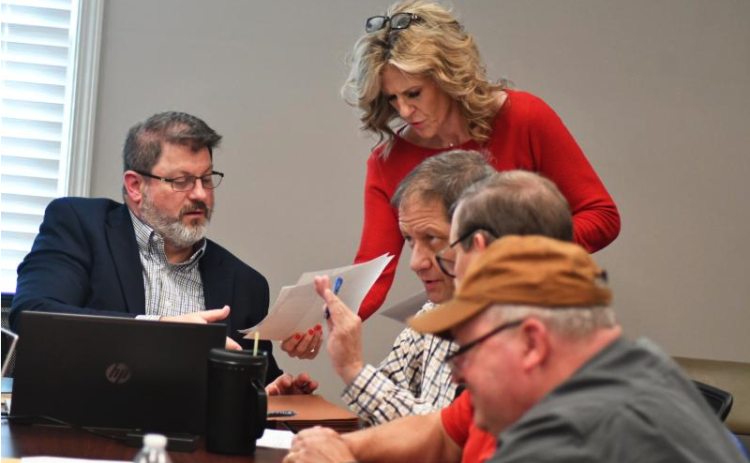 File Photo/Enoch Autry/The Clayton Tribune. RCWSA Finance Director Traci Adams hands paperwork to Jarrard & Davis, LLC Attorney Jeffrey M. Strickland. The sale and closing on the water and sewer system between the City of Clayton and RCWSA was a significant event in 2024.