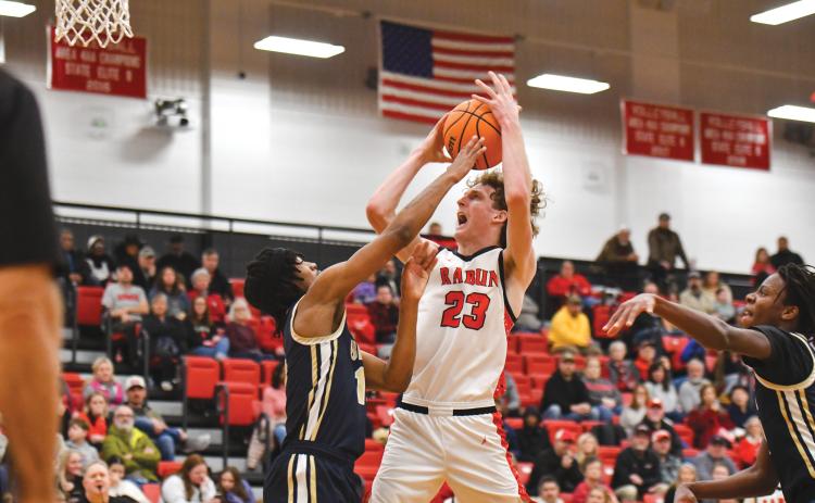 Wade Cheek/The Clayton Tribune. Rabun County junior post Hayes Free draws a foul at the rim during Rabun’s Sweet-16 loss to BEST Academy on Saturday, Feb. 22. Free scored a team-high 19 points against the Eagles.