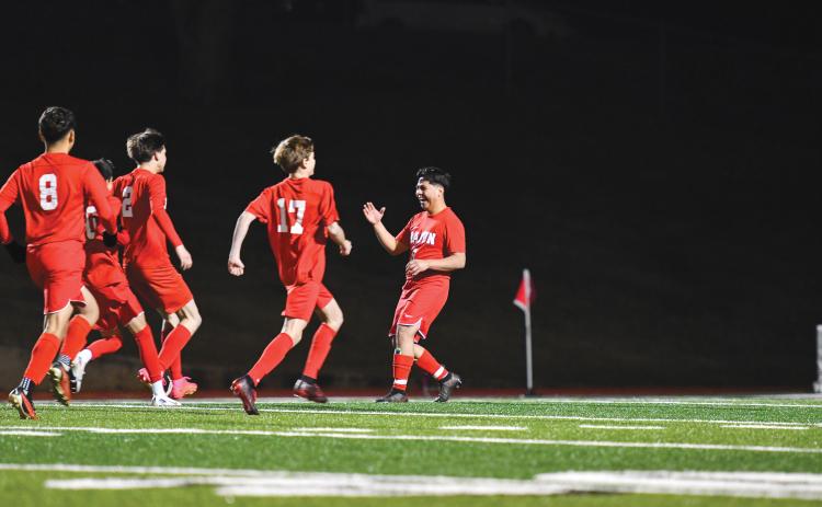 Wade Cheek/The Clayton Tribune. The Rabun County boys soccer team celebrates its victory over North Hall after winning in a penalty-kick shootout. The Wildcats were tied at zero with the Trojans before winning the tie-breaking shootout.