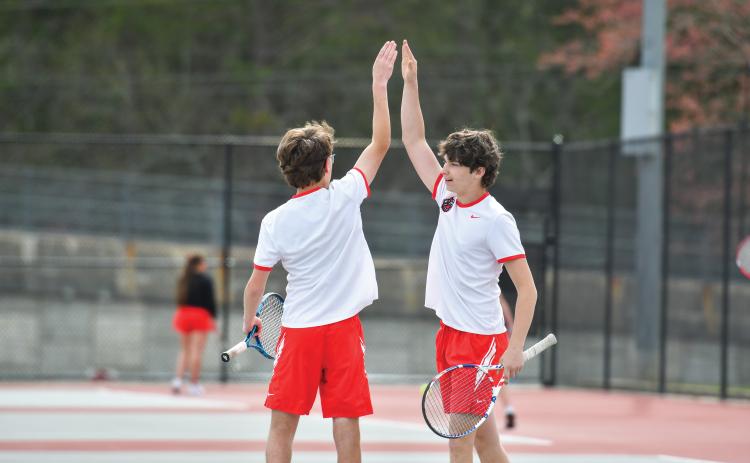 Wade Cheek/The Clayton Tribune. No. 1 Wildcat duo Robbie Fountain and Brady Darnell celebrate a point in their victory over Banks County’s duo (6-0, 6-4). The Wildcats defeated the Leopards 4-1.