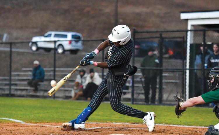 Wade Cheek/The Clayton Tribune. Senior second baseman Denajh Williams strips a base hit into the outfield in Rabun Gap’s 19-0 win over Tallulah Falls earlier this season.