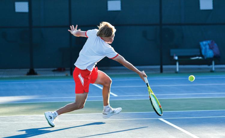 Wade Cheek/The Clayton Tribune. RCHS sophomore No. 2 singles player Landan Bedingfield returns a serve in last week’s region championship match against Athens Academy. Bedingfield lost in the region title, but rebounded with a first-round playoff win, defeating his Jasper County opponent (6-0, 6-1).